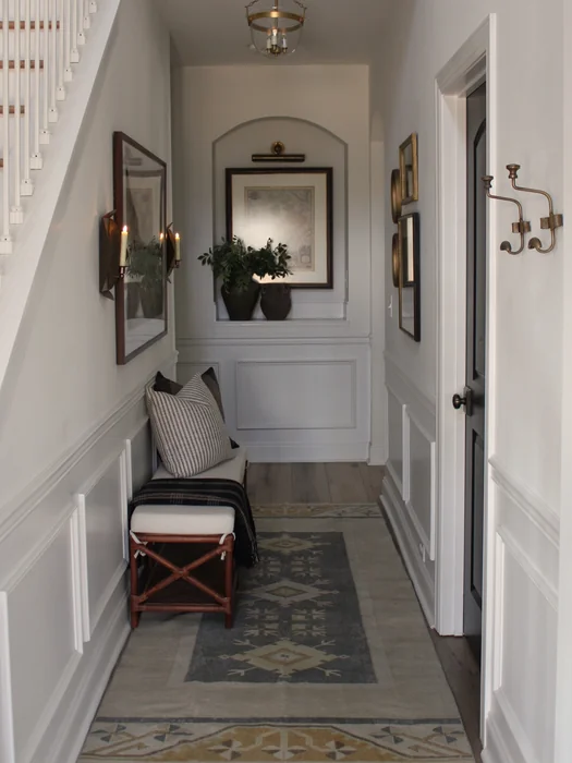 Narrow Hallway Entryway with Arched Niche and Wainscoting