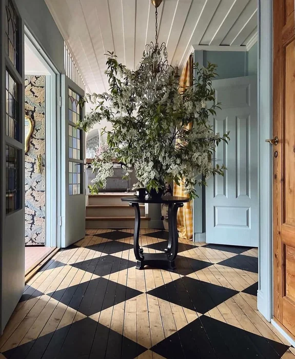 Dramatic Entryway with Checkerboard Floor and Oversized Floral Display