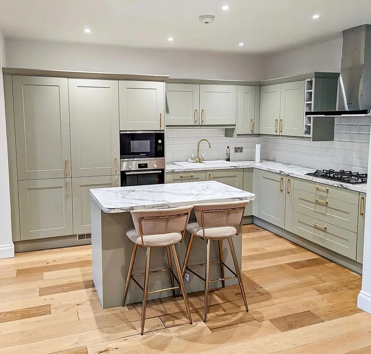 Sage Green Kitchen with Marble Island and Gold Accents