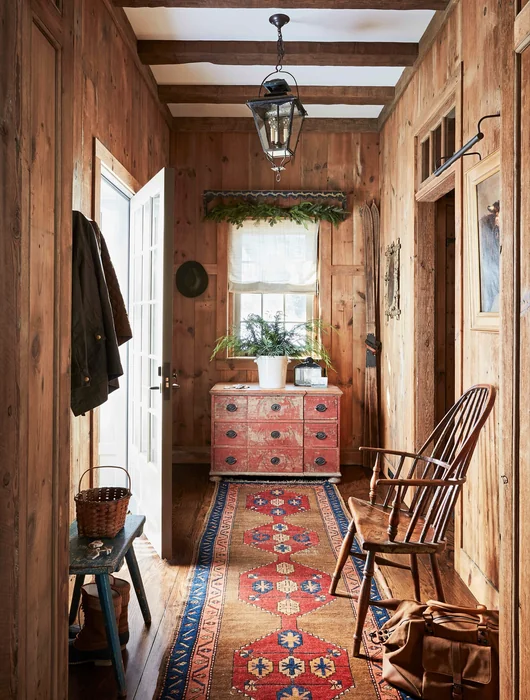 Cozy Log Cabin Entryway with Rustic Dresser and Knotty Pine Walls