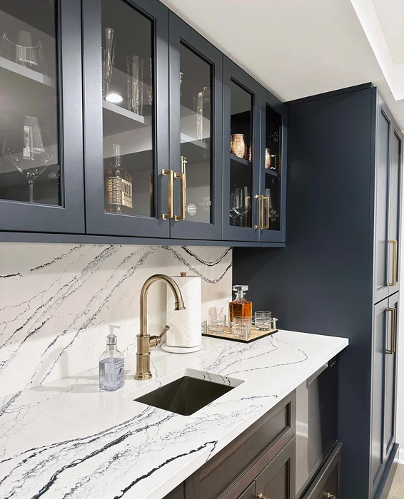 Navy Blue Butler's Pantry with Glass Cabinets and Marble Backsplash