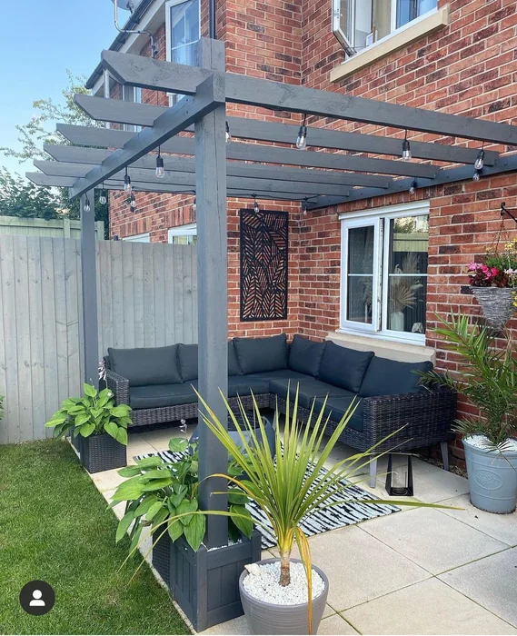 Small Garden Pergola with String Lights and Wall Art