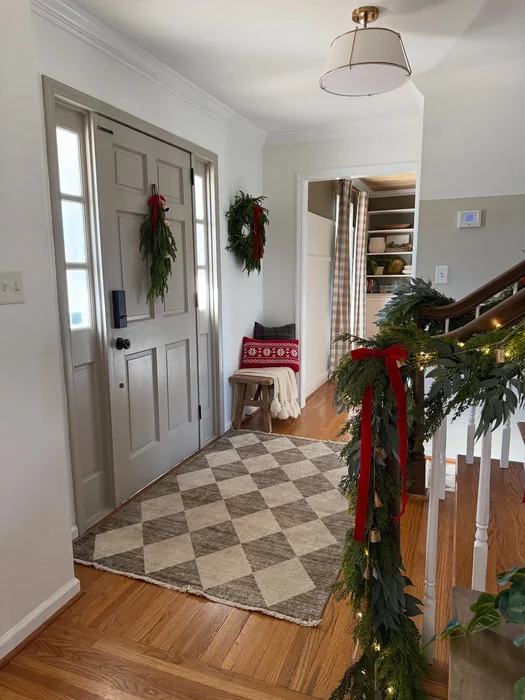Christmas Entryway with Garland Staircase and Festive Wreaths