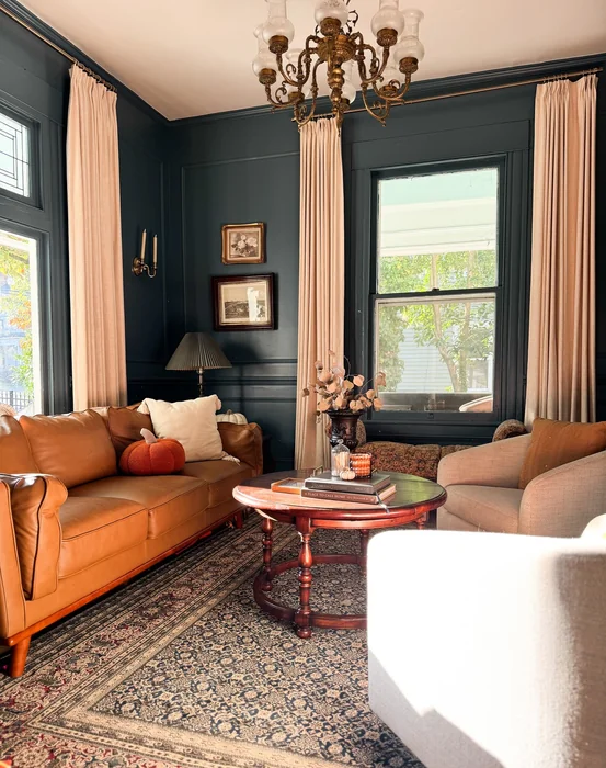 Moody Dark Fall Living Room with Leather Sofa & Velvet Pumpkins