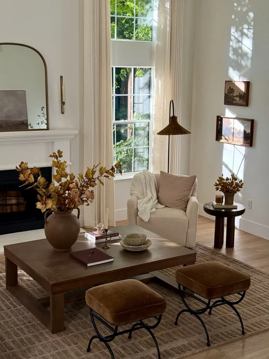 Elegant Fall Living Room with Brown Velvet Ottomans & Fireplace