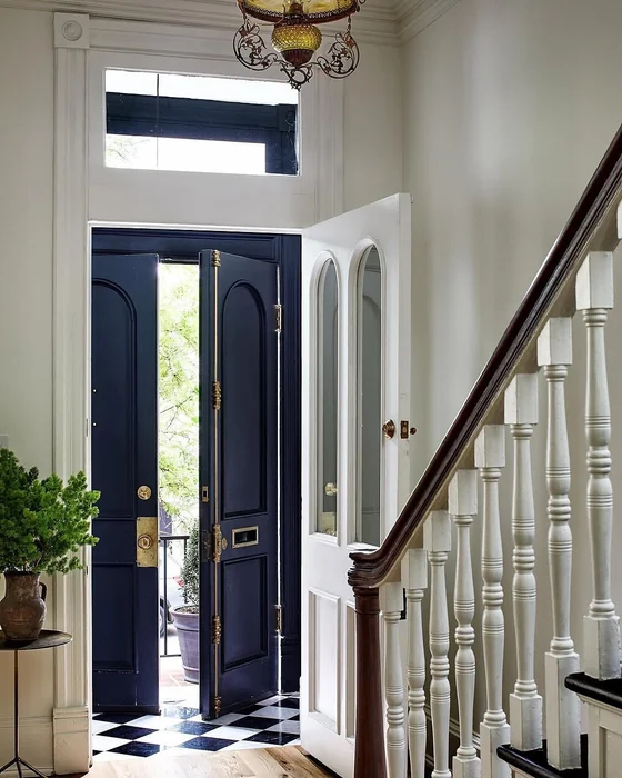 Grand Foyer with Navy Double Doors and Checkerboard Marble Floor