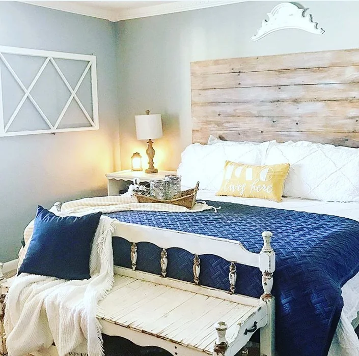 White Crown Ornament Above Farmhouse Bed