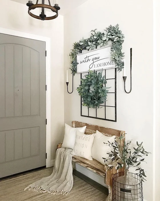 Farmhouse Entryway with Greenery Wall Display and Rustic Bench