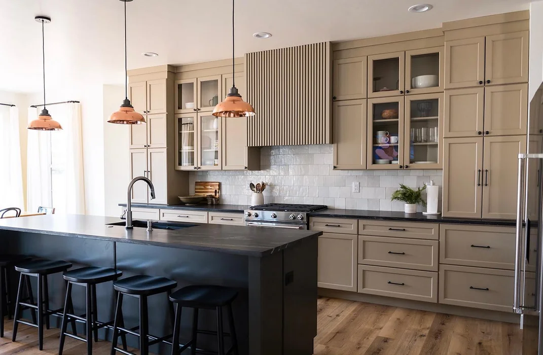 Greige Kitchen with Tall Glass Cabinets and Copper Pendants