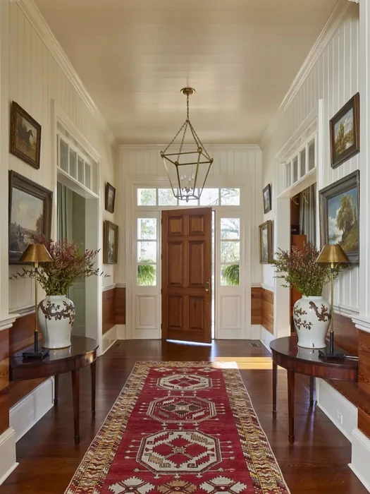 Formal Symmetrical Foyer with Twin Side Tables and Red Runner Rug