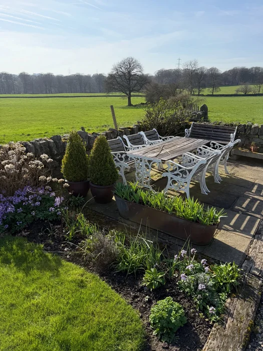 Countryside Patio with Ornate White Iron Chairs and Open Views