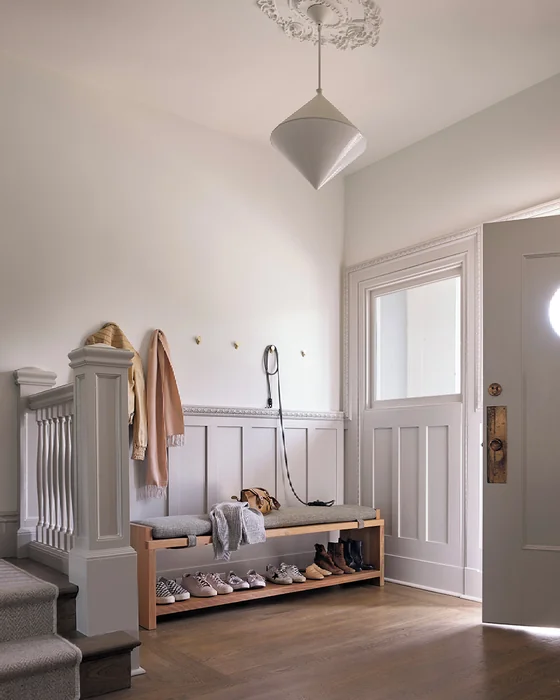 British-Style Entry Hall with Oak Bench, Shoe Rack, and Wall Hooks