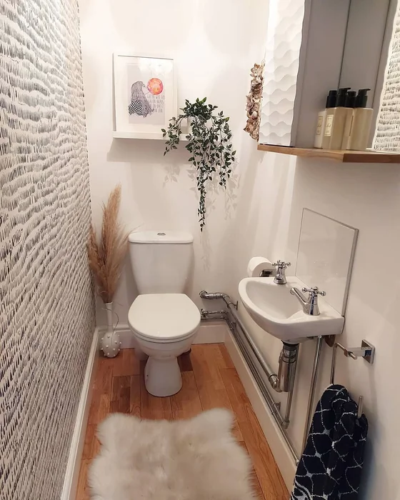 Tiny Half Bathroom with Bold Wallpaper and Boho Touches