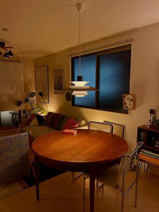 Round Teak Dining Table with Pendant Lamp — Cozy Night Vibe
