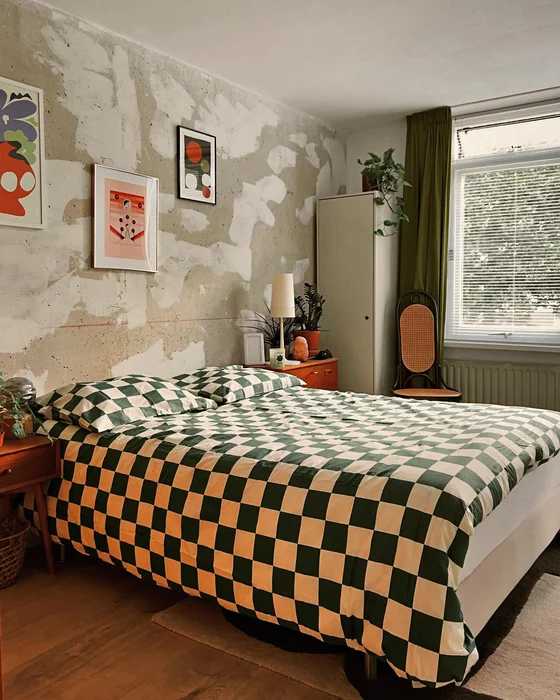 Eclectic Vintage Bedroom with Raw Plaster Wall and Framed Art