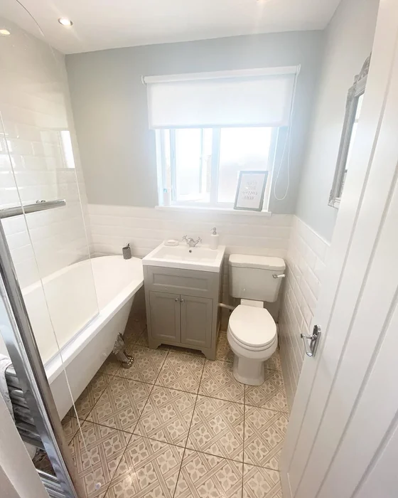 Simple Small Bathroom with Soft Grey Vanity and Patterned Floor