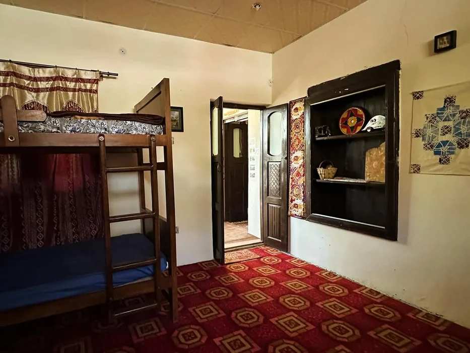 Cultural Hostel Room with Bunk Bed and Built-In Shelf