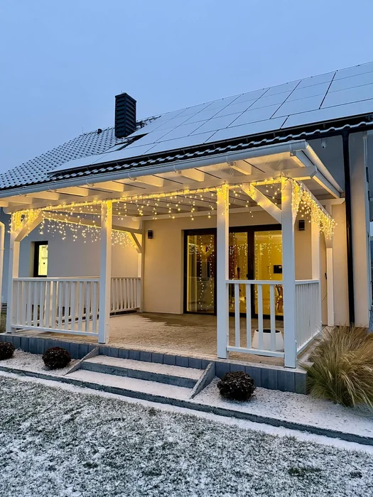 White Porch with Warm Icicle Lights at Dusk