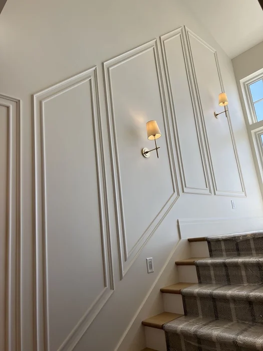 Classic Panel Moulding with Sconces Going Up Stairs