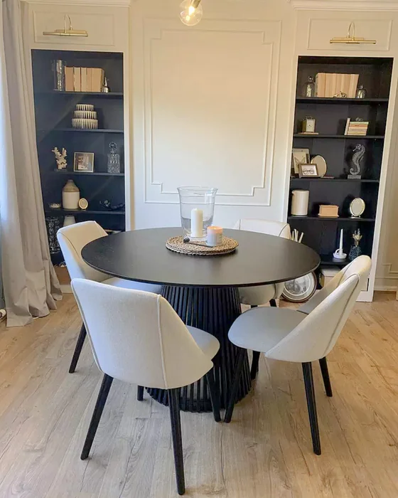 Black Round Dining Table with Slatted Base and Candle Centerpiece