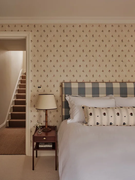 English Country Bedroom with Delicate Floral Wallpaper Accent Wall