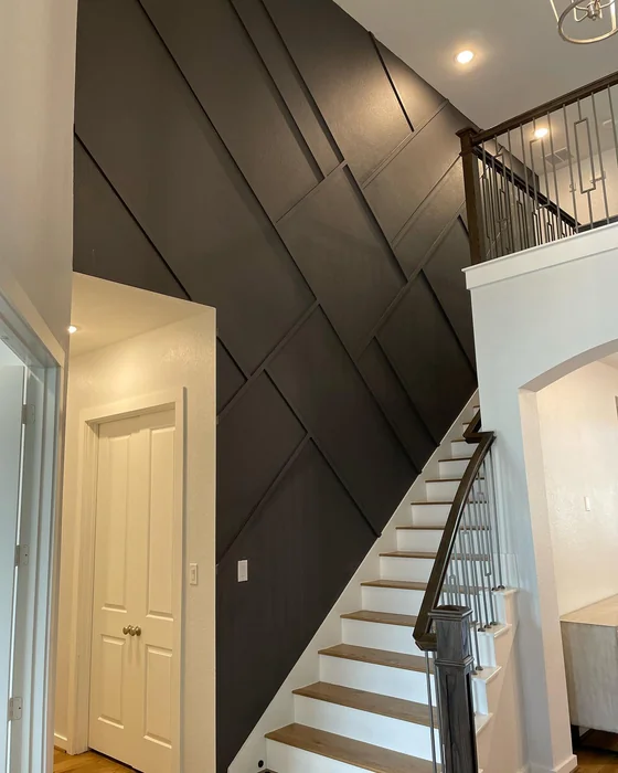 Dark Diagonal Panel Accent Wall by Tall Staircase