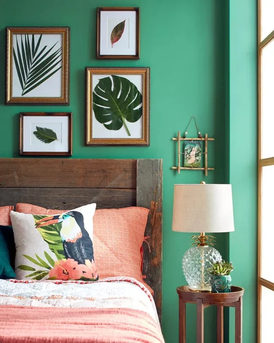 Tropical Bedroom with Framed Leaf Prints on Green Wall