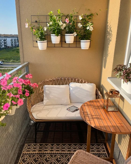 Small Balcony with Rattan Sofa and Wall Plant Grid
